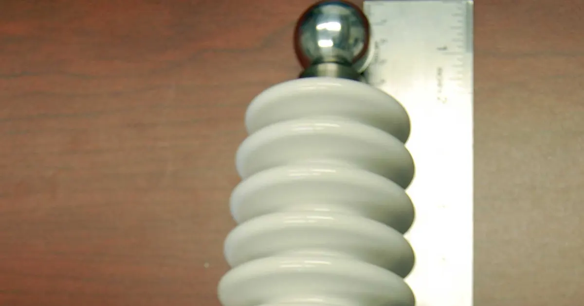 White ribbed ceramic insulator of a 60 kV vacuum feedthrough